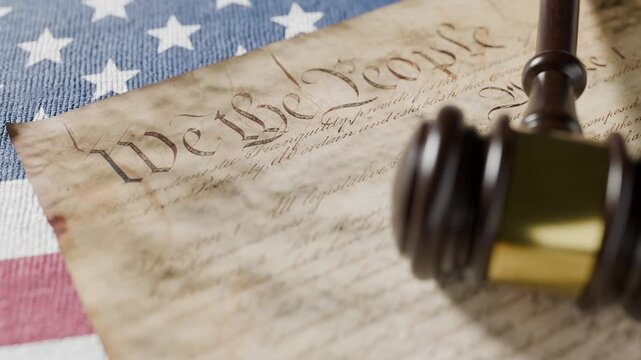 United States Constitution, Gavel and American Flag Resting on Table.