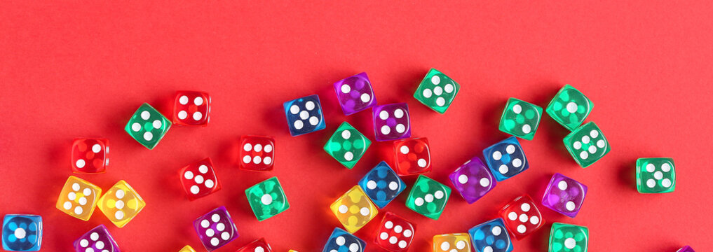 Many dices on red background, top view