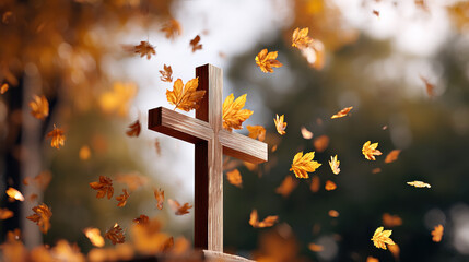 Wooden cross surrounded by autumn leaves falling gently, creating peaceful and spiritual atmosphere outdoors with warm sunlight and blurred background
