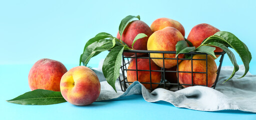 Basket of fresh peaches on blue background