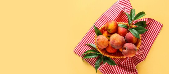 Basket of fresh peaches on color background with space for text, top view