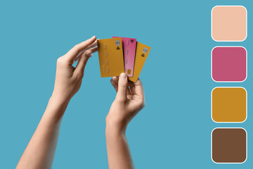 Hands with credit cards on blue background. Different color patterns