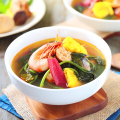 National cuisine of the Philippines - Sinigang - a broth based on meat, shellfish (bangus), shrimp, tamarind (a sweet and sour fruit) and vegetables.