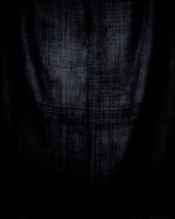 Dark textured fabric abstract artistic backdrop