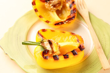 Plate with tasty grilled bell pepper on beige background