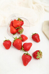 Glass with fresh strawberries on white background