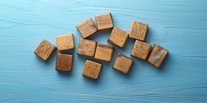 Wooden letter tiles spelling out economic downturn on a stylish blue backdrop. Concept of financial crisis and global recession. Birds eye view