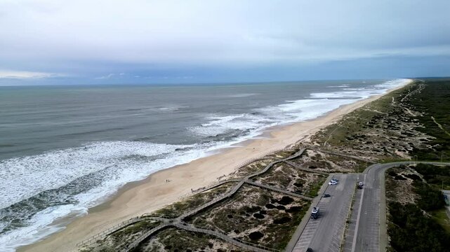 Aerial view of Praia da Tocha beach with waves, Portugal.
