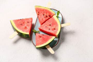PLate with sweet watermelon sticks and mint on white background