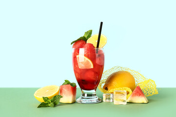 Glass of fresh watermelon lemonade with mint on green table