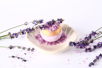 Composition with bath bomb and aromatic lavender flowers on light background
