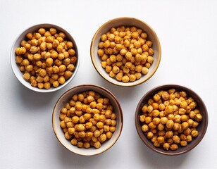 crispy roasted chickpeas served in bowls against a white background vegetarian vegan food idea top view flat lay