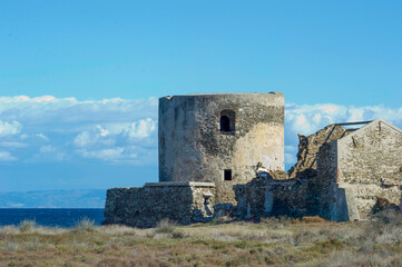 ruins of the old fortress, Scenic view of Saline tower against the scattered clouds at midday. Stintino, Sardinia. Italy 