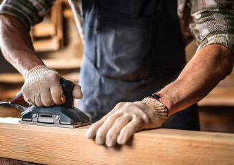 carpenter cutting wood with saw