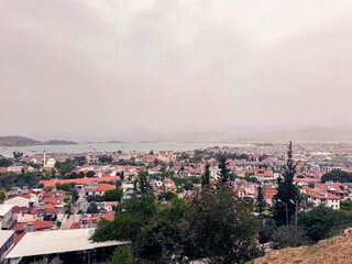 Picturesque view of a coastal town under cloudy skies near the water