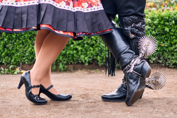 View of the feet or legs of Chilean huasos, posing and showing details of their traditional attire,...