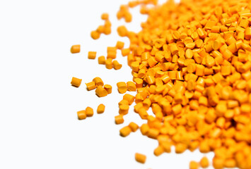 Yellow plastic polymer granules isolated on white background 