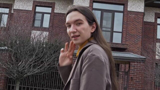 guy model with long hair walks to beautiful big ho