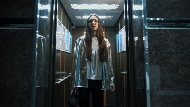 teenager with long hair standing in elevator