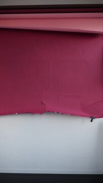 rolling up vibrant paper at studio