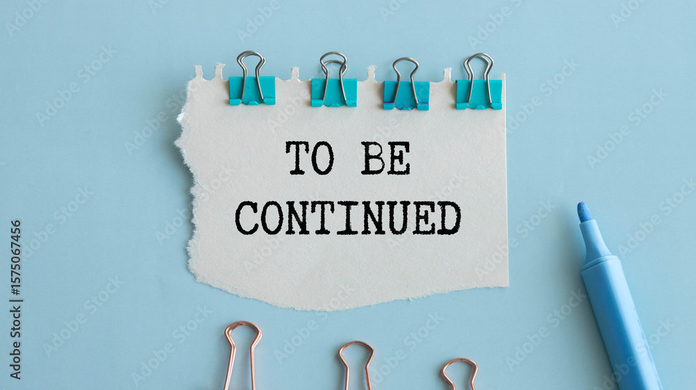 Poster to be continued text message and alarm clock on wooden background