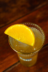 A vibrant cocktail with an orange slice garnish is a refreshing summer drink.