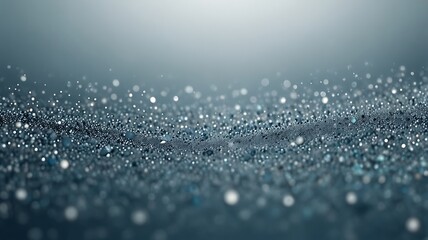 Abstract textured background featuring a water surface. The small water droplets appear to glitter and glisten. The focus is sharp in the foreground and gradually blurs toward the top.
