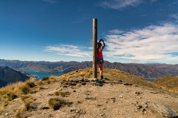 Rear view of hiker enjoying the  views of lake Hawea from the Isthmus track walkway