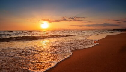 sunset casts a warm golden glow on the sea and sand