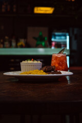 A delicious plate of food served with a refreshing cocktail, ready to enjoy.
