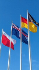 Four flags waving against a clear blue sky showcasing poland iceland germany and the european union