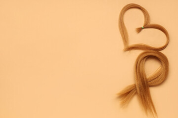 Fototapeta premium Red hair strands for donation on orange background