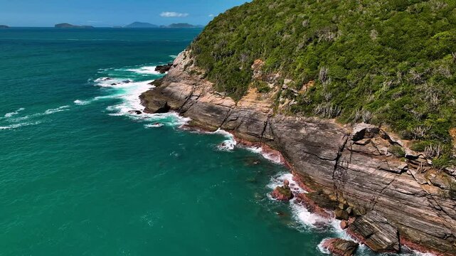 Aerial view of tropical waves crashing on rocky coast, Brazil.
