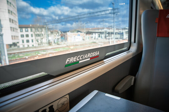 ROME, ITALY - JANUARY 15, 2025: Frecciarossa logo on the window of an Italian high speed train, seen from a passenger seat. Frecciarossa is Trenitalia high speed rail service.
