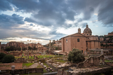 Sunset colours wash the Roman Forum, scattered columns and the church of Santi Luca e Martina...