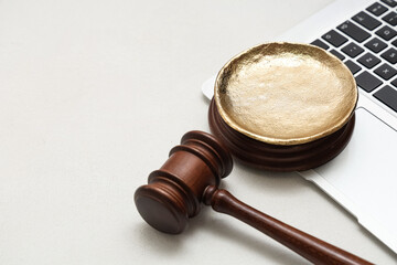 Antique plate with auction gavel and laptop on white grunge background, closeup
