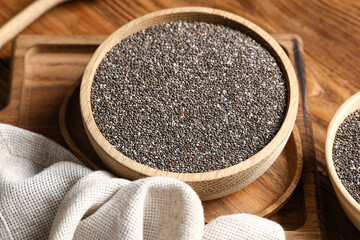 Bowl with chia seeds on wooden background, closeup