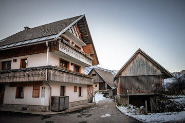 Typical wooden alpine chalet, used as a residential building, in the city center of Stara Fuzina, in Bohinj, Slovenia, in the julian alps.
