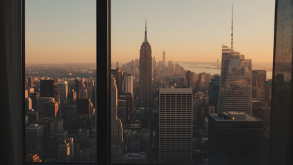 Panoramic cityscape view of New York City from a high-rise building at sunset.