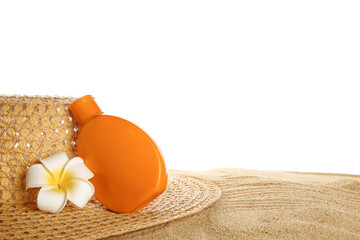 Hat, plumeria flower and bottle of sunscreen cream on sand against white background