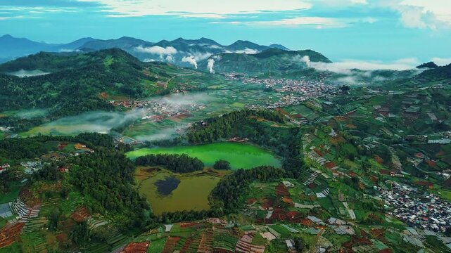 Beautiful aerial view footage of the Color Lake in Dieng Plateau, Wonosobo, Central Java, Indonesia. 4k resolution