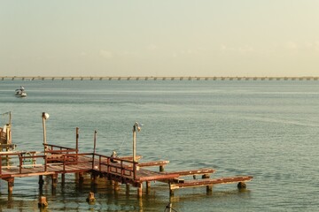 Man fishing on a wooden jetty located at South Padre Island and watching the sunset