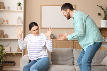 Young man quarreling with his wife at home