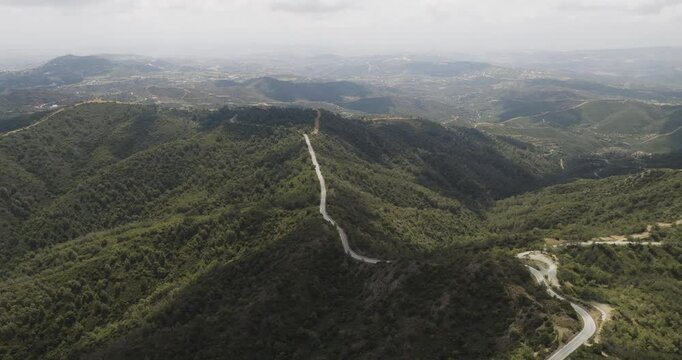 Aerial view of Troodos Mountains and winding road, Cyprus.