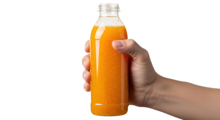 A hand holding a clear plastic bottle filled with orange liquid against a black background image shot