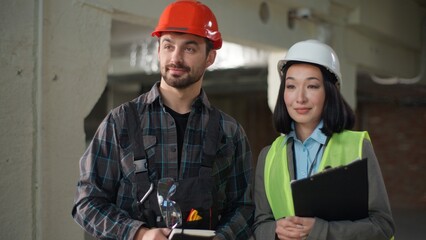 Happy multiethnic business builders inspection success construction project build site Korean Asian...