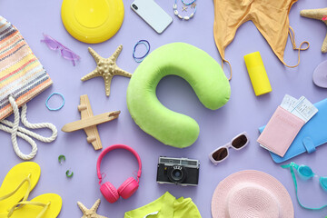 Composition with photo camera, mobile phone and beach accessories on lilac background
