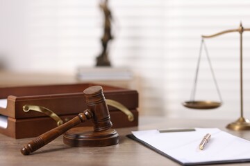 Judge. Gavel, scales, clipboard and pen on wooden table in office, selective focus