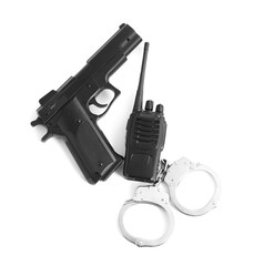 Gun, handcuffs and walkie talkie on white background, top view. Police equipment