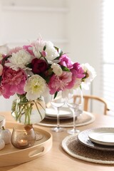 Beautiful table setting with bouquet of peonies indoors, closeup